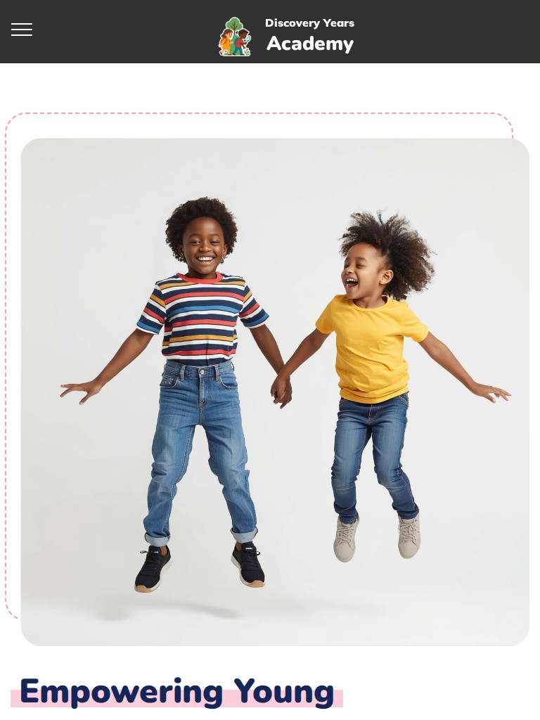 Discovery Years Academy homepage showing two children jumping beside a message about empowering young minds on tablet