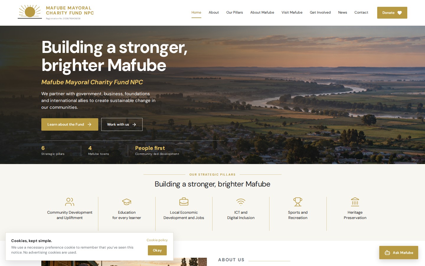 Mafube Mayoral Charity Fund website with gold branding, a river landscape and six community development pillars on desktop